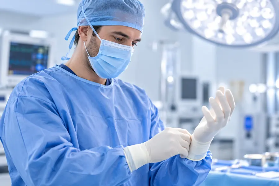Plastic surgeon preparing for a procedure in a modern operating room